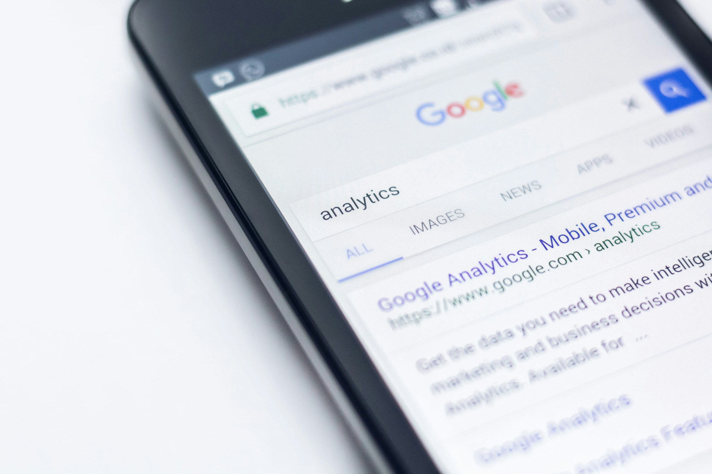 A smartphone displays a Google search results page for the keyword "analytics.