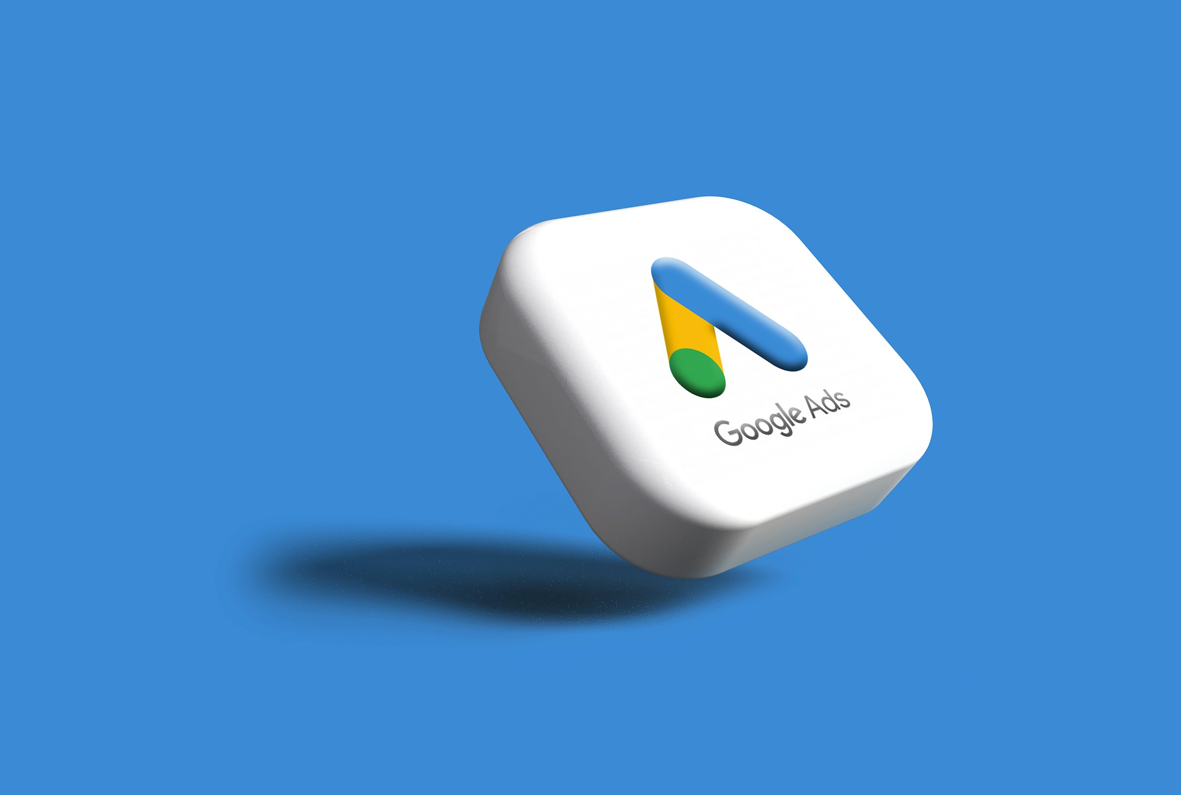 A 3D Google Ads icon with the Google Ads logo on a blue background.